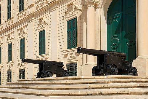 Valetta, Malta. Government building with ancient canons lined up in front of the entry. Art Print